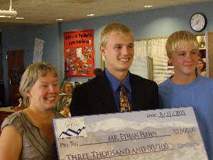 Hahn (c), the Grand Prize winner of the AFCEA National High School Science Fair, joins his mother Jolene and his brother Cody to celebrate at the chapter's August event.